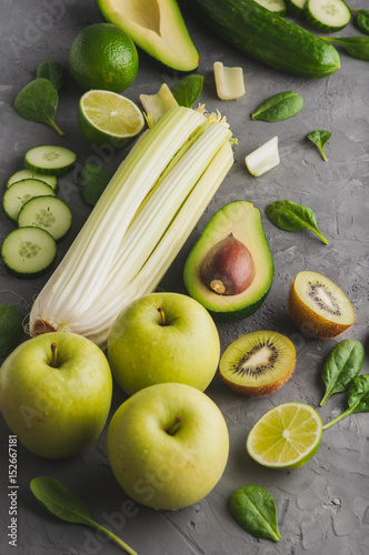 A set of fresh,green fruits and vegetables on a grey concrete background.Top view.
