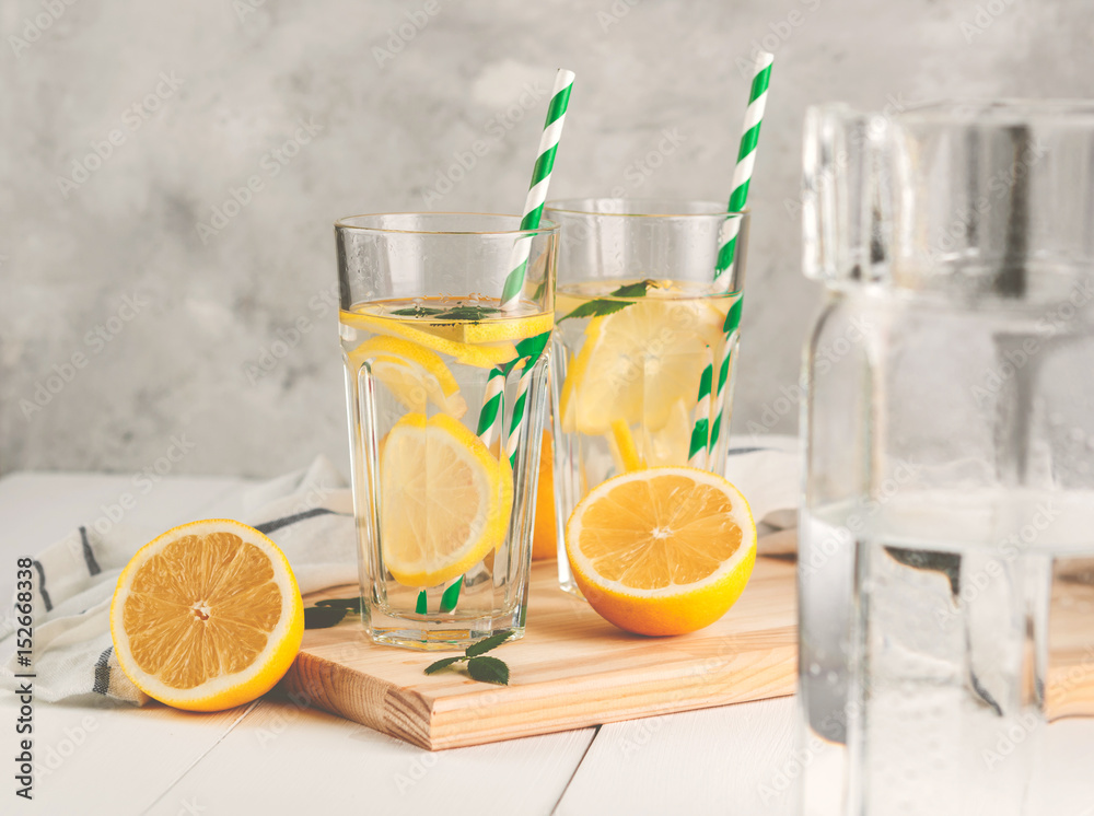 Fresh citrus lemonade in the glasses,concrete grey background, place for text. Fresh citrus lemonade in the glasses,concrete grey background, place for text.