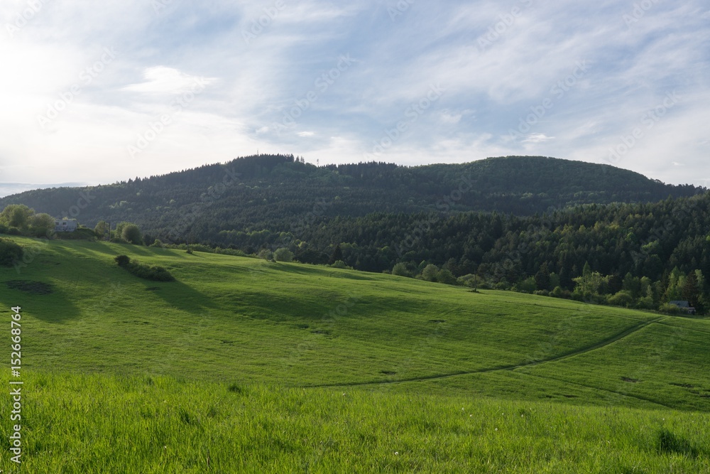 Dramatic clouds on a green meadow, sunrise and sunset in nature. Slovakia