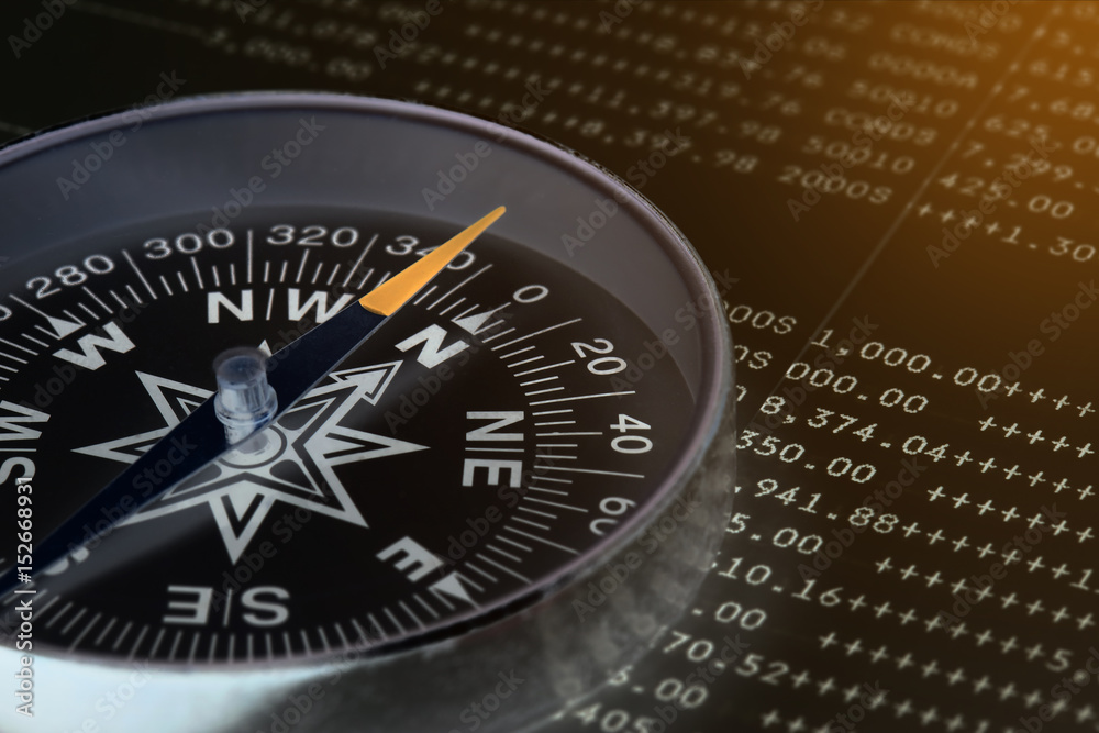 Conceptual compass on account book for finance Conceptual compass on account book for finance