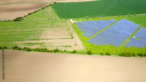 Aerial view of solar power plant in a middle of agriculture landscape. photo