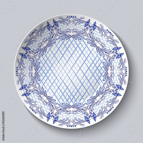 Dish painted with blue national patterns in the style of painting on porcelain isolated on gray.