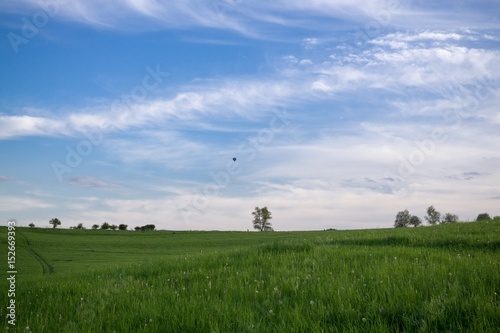 Paraglider and balloon flying in the air during colorful sunset. Slovakia