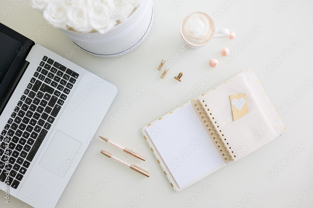 Diary with blank paper, flower bouqet and laptop, coffee on white table Diary with blank paper, flower bouqet and laptop, coffee on white table