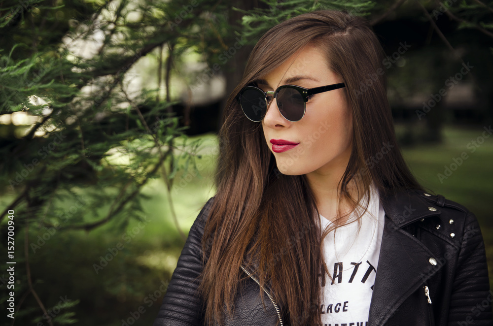 Sexy young woman with trendy sunglasses in park Sexy young woman with trendy sunglasses in park