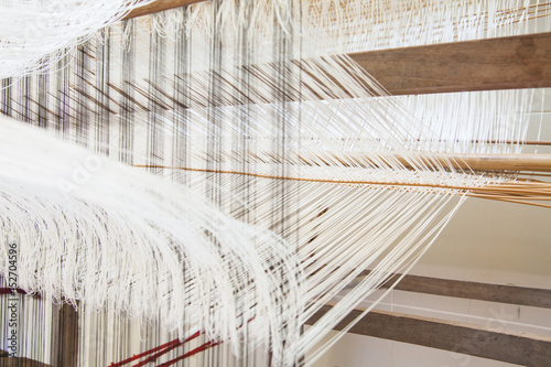 old weaving Loom and thread of yarn.