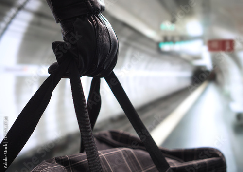 Foto Close up of terrorist holding black bag in hand, possibly timebomb