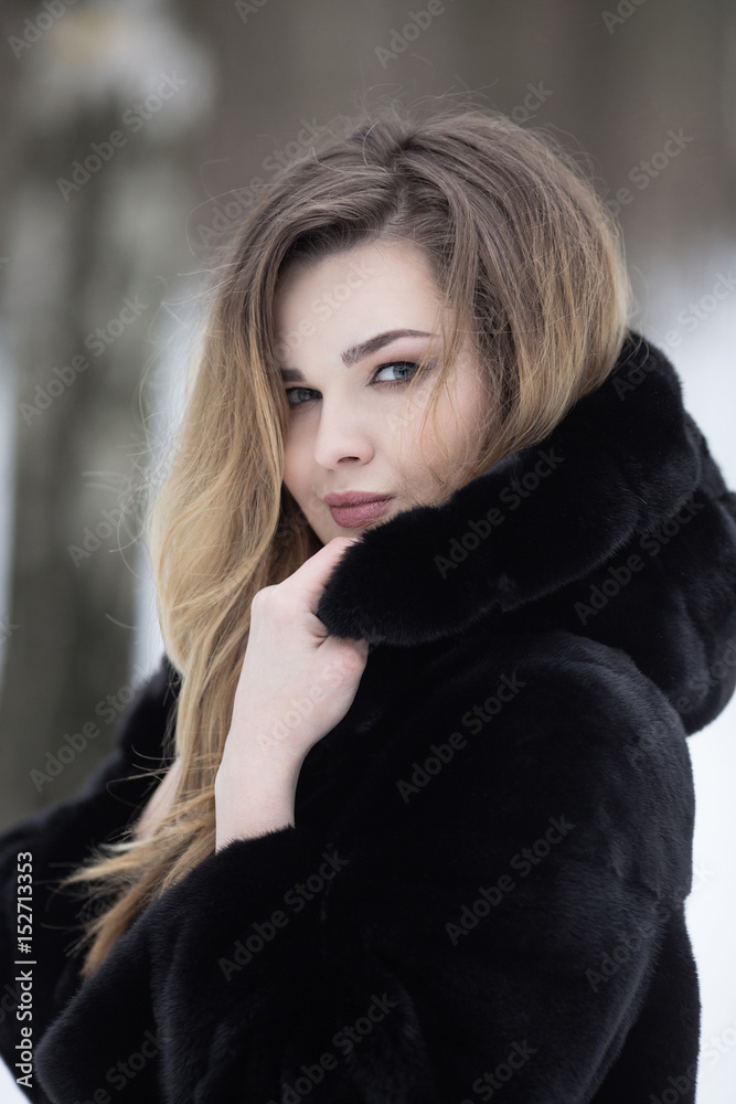 Fashionable winter portrait of lady with long hair in city Fashionable winter portrait of lady with long hair in city