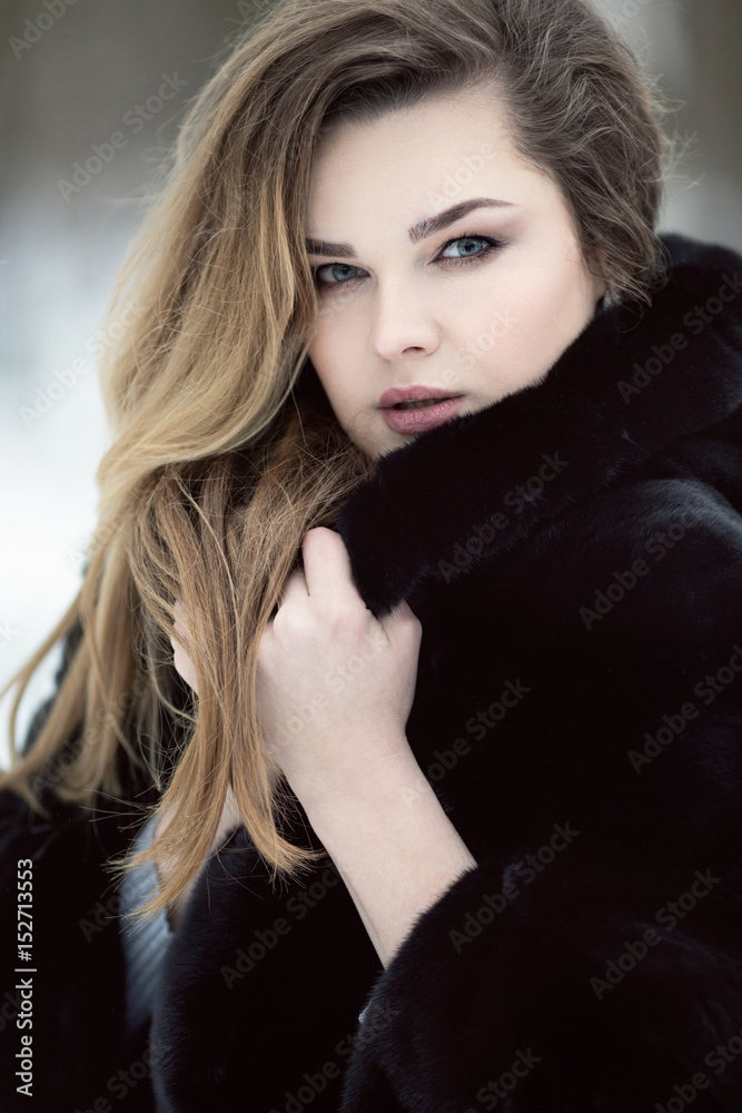Fashionable winter portrait of lady with long hair in city Fashionable winter portrait of lady with long hair in city