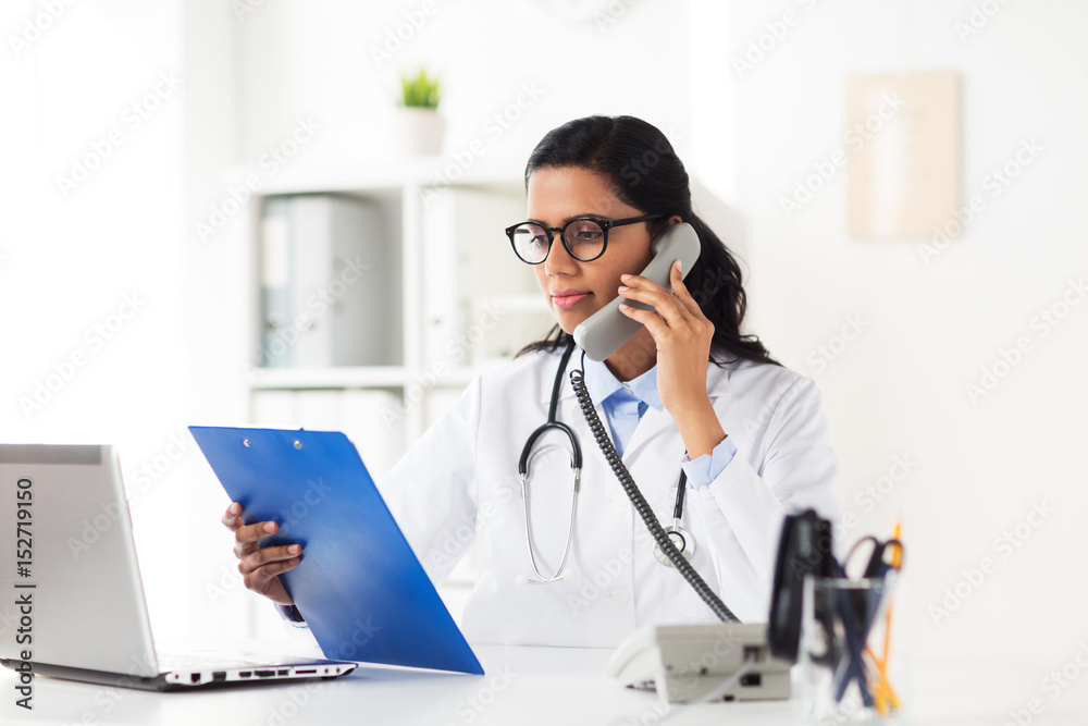 doctor with clipboard calling on phone at hospital doctor with clipboard calling on phone at hospital