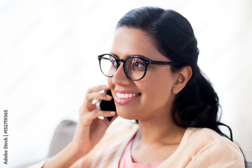 happy indian woman calling on smartphone at home happy indian woman calling on smartphone at home