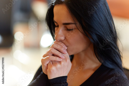 Photography close up of unhappy woman praying god at funeral