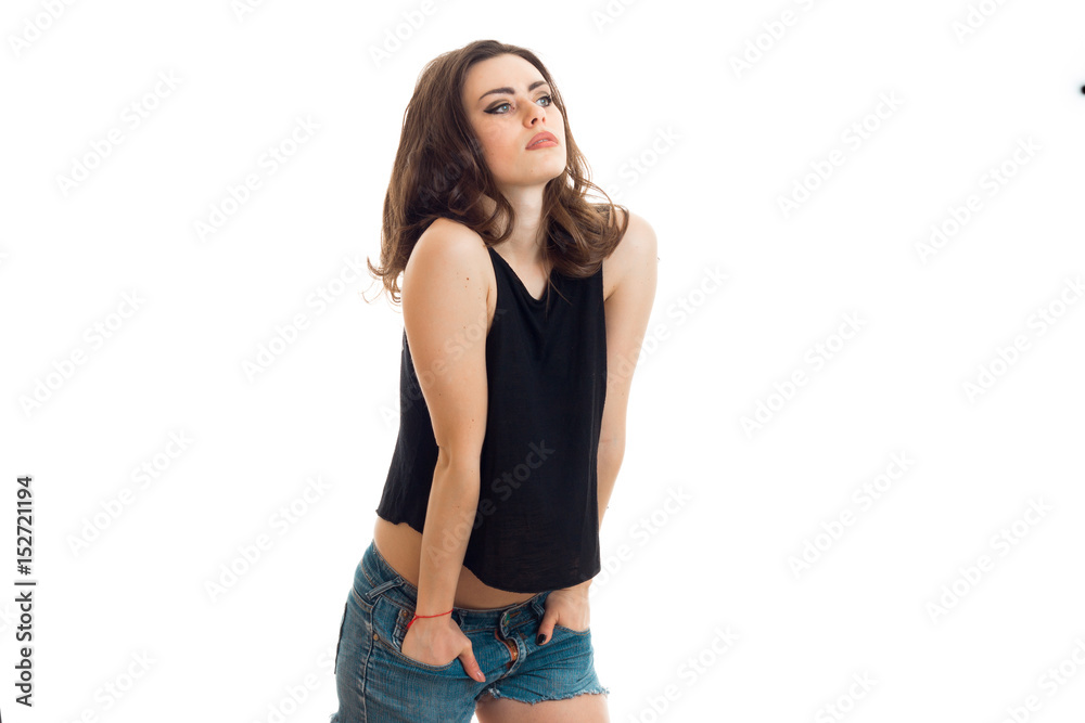 charming brunette teen looks away and keeps hands in pockets charming brunette teen looks away and keeps hands in pockets