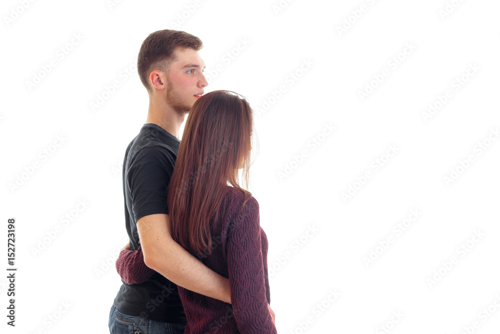 loving young couple hug each other and stand backside loving young couple hug each other and stand backside