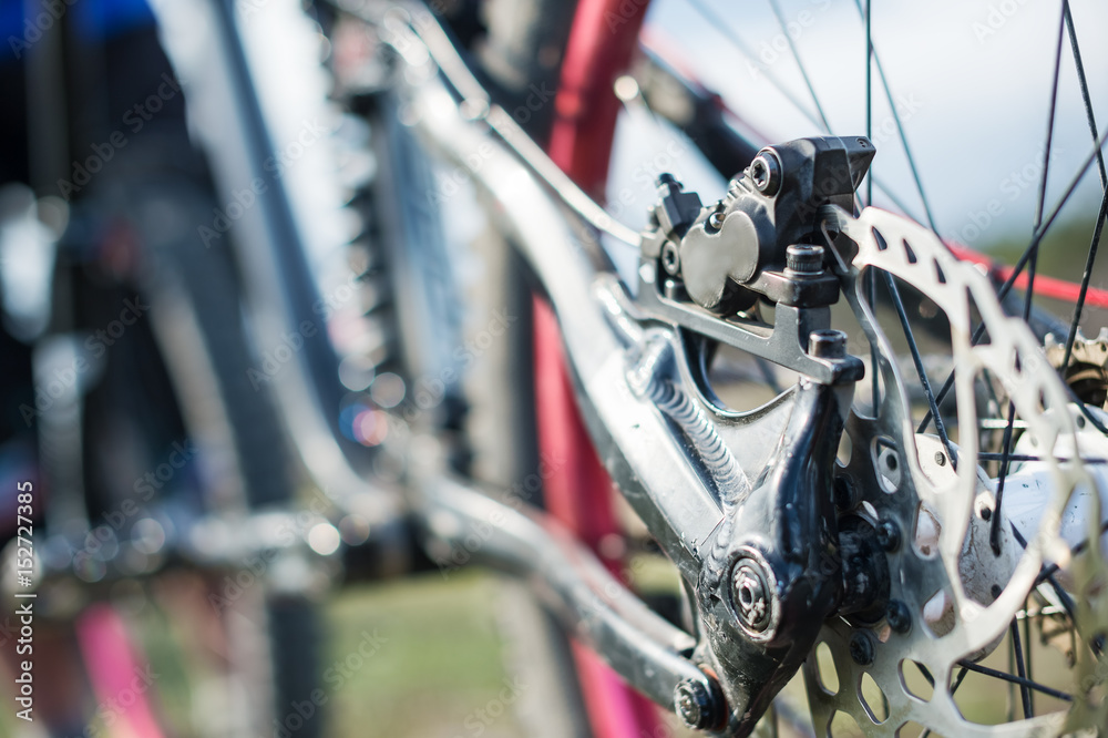 Elements of the suspension of the mtb bike of a two-pendant mountain bike close-up brake disc brake Elements of the suspension of the mtb bike of a two-pendant mountain bike close-up brake disc brake