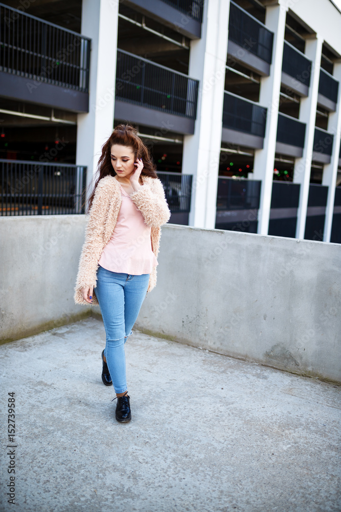 young beautiful happy girl in a coat posing at the street young beautiful happy girl in a coat posing at the street
