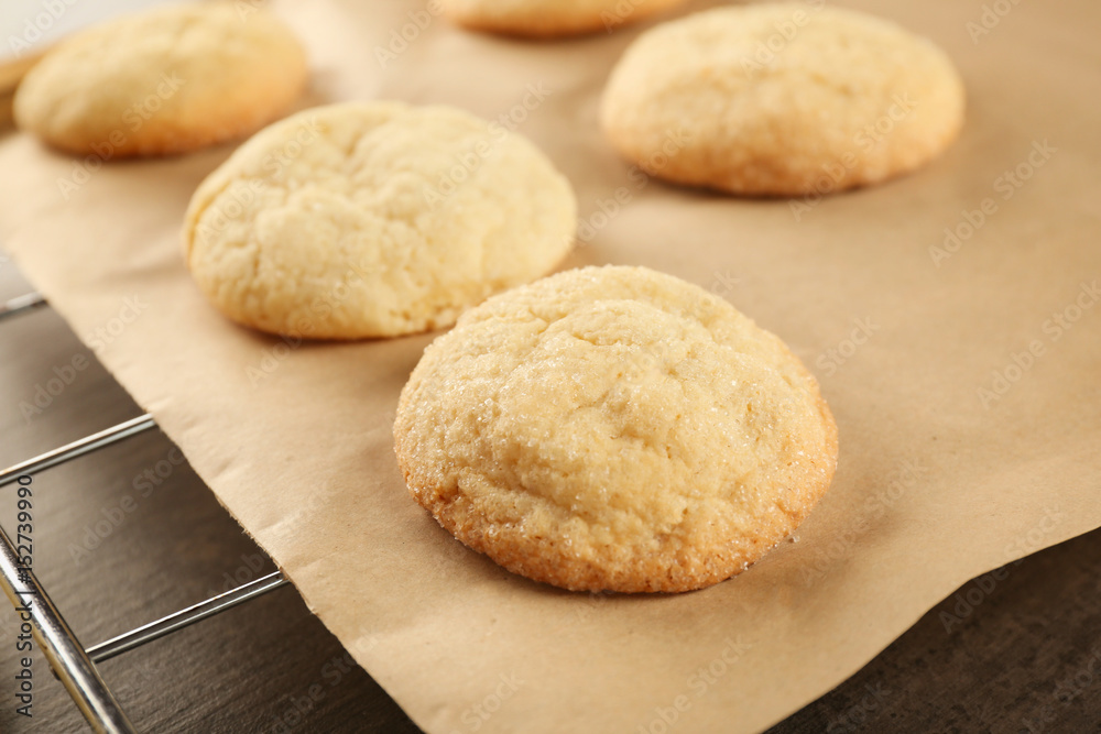 Tasty sugar cookies on parchment paper, closeup
