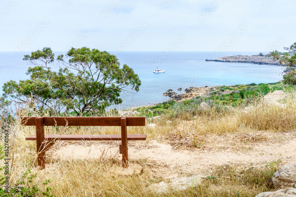 Bench in the park Cavo Greco overlooking Sea