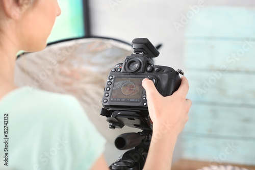 Young woman looking at camera display, closeup