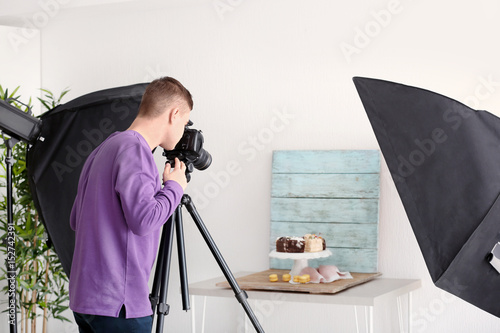 Young man photographing foo...