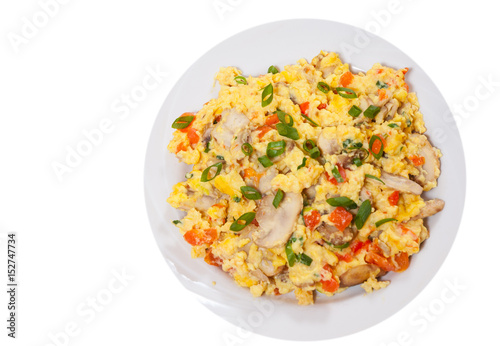 scrambled eggs with mushrooms and vegetables. top view. isolated on white