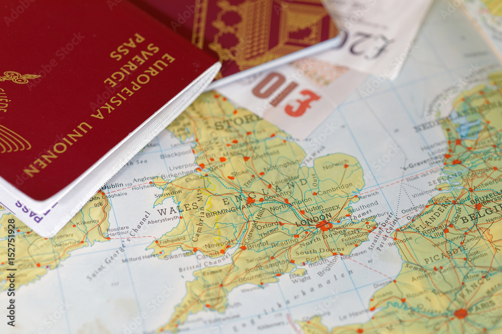 Passport and english pound bill on a map of United Kingdom
