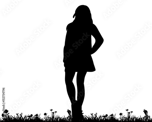  silhouette of a teenager standing on the grass