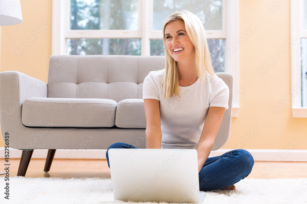 Happy young woman using her laptop Happy young woman using her laptop