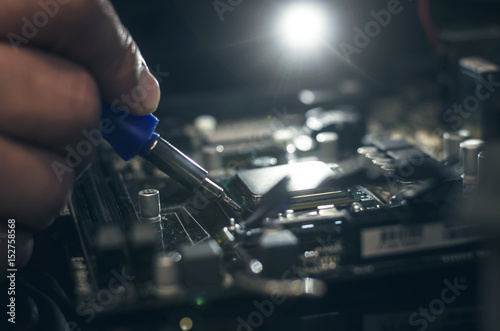 Computer processor. Technician removes CPU from the motherboard.
