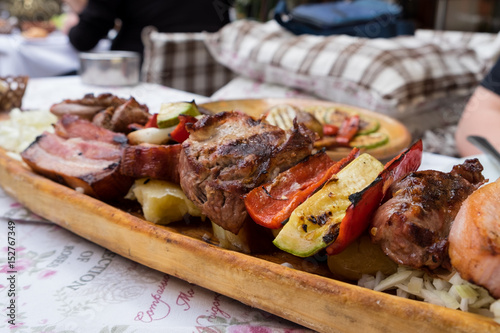 Serbian specialities known as rostilj include grilled pork neck, beef steak and vegetables  photo
