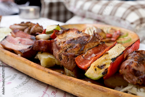 Serbian specialities known as rostilj include grilled pork neck, beef steak and vegetables  photo