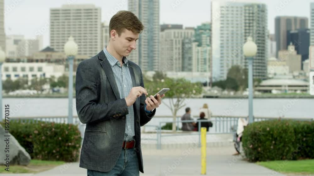 Two young men in suits on a sidewalk in Coronado