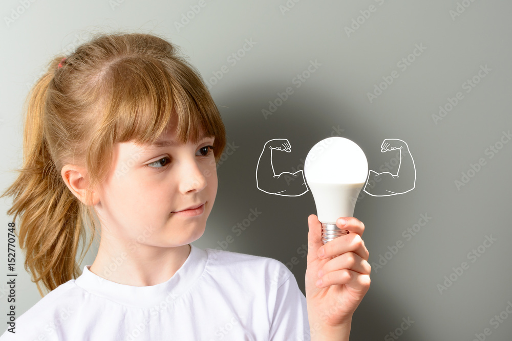 Cute little girl holding a luminous led light bulb Cute little girl holding a luminous led light bulb