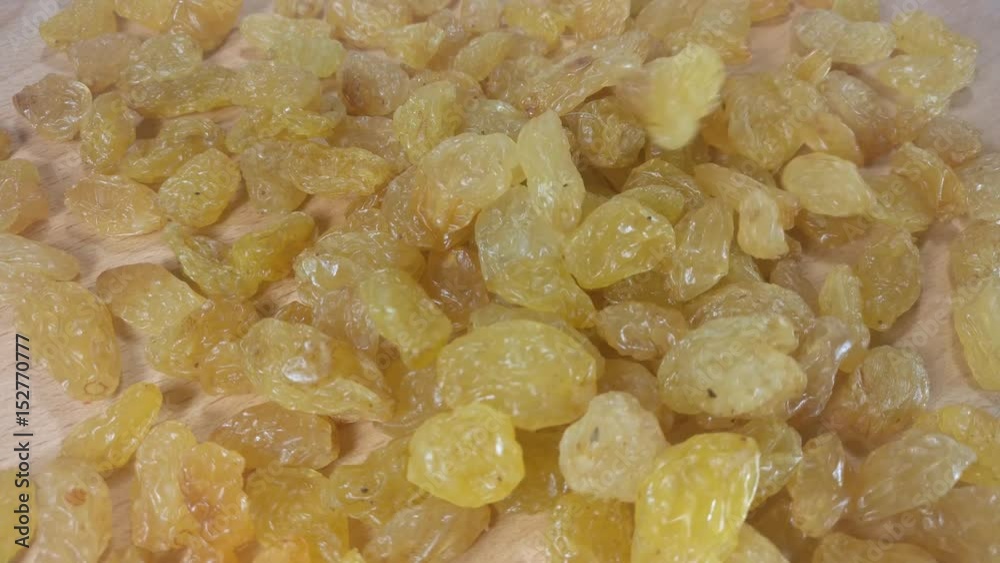 Delicious raisins. Amber raisins falling on wooden background. Slow motion video.
Delicious raisins. Amber raisins falling on wooden background. Slow motion video.