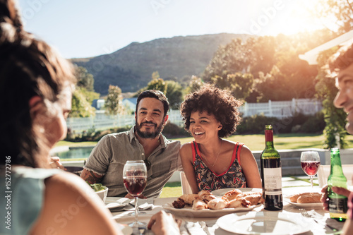 Group of people having alfresco meal
