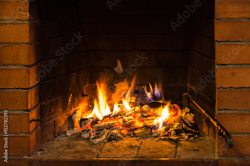 fire on burnt woods in fireplace