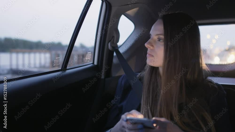 Woman Looking Through the Window and Using a Mobile