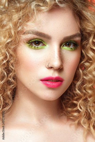 Beautiful woman portrait with bright summer make up and freckles on face. 