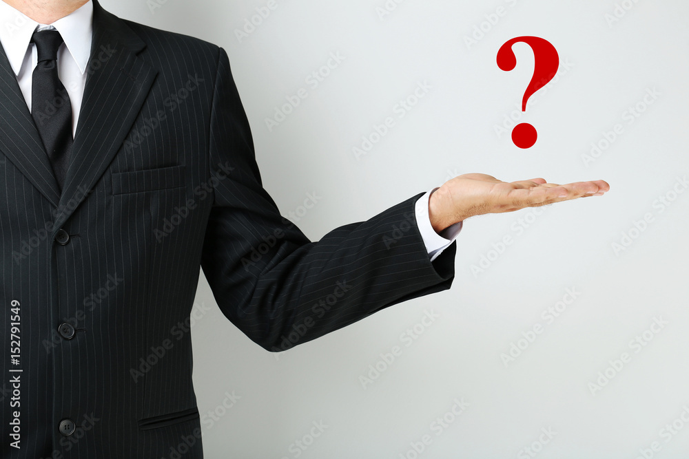 Businessman gesturing with his hand on grey background Businessman gesturing with his hand on grey background