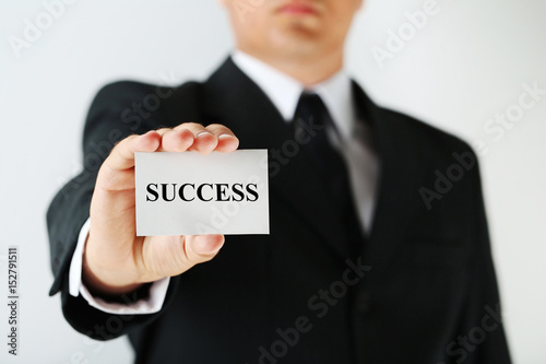 Businessman holding card with word Success