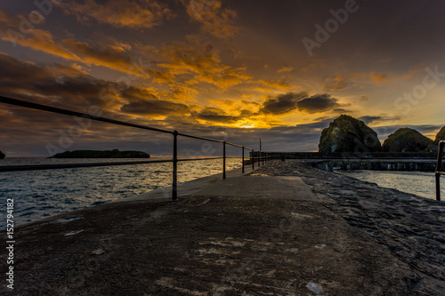 Sun setting over Mullion Cove Harbour