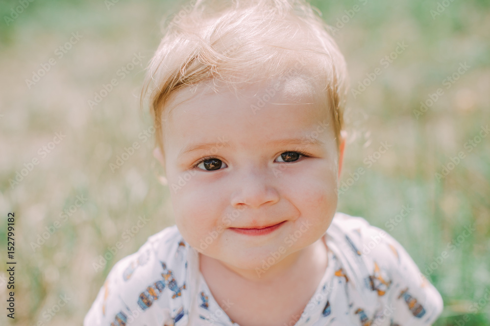 Serious 1-year infant boy during his first haircutting Serious 1-year infant boy during his first haircutting