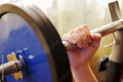 Male hand holding a barbell