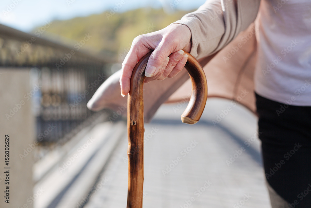 Fototapeta premium Good looking woman drawing on stick in her hands outdoors