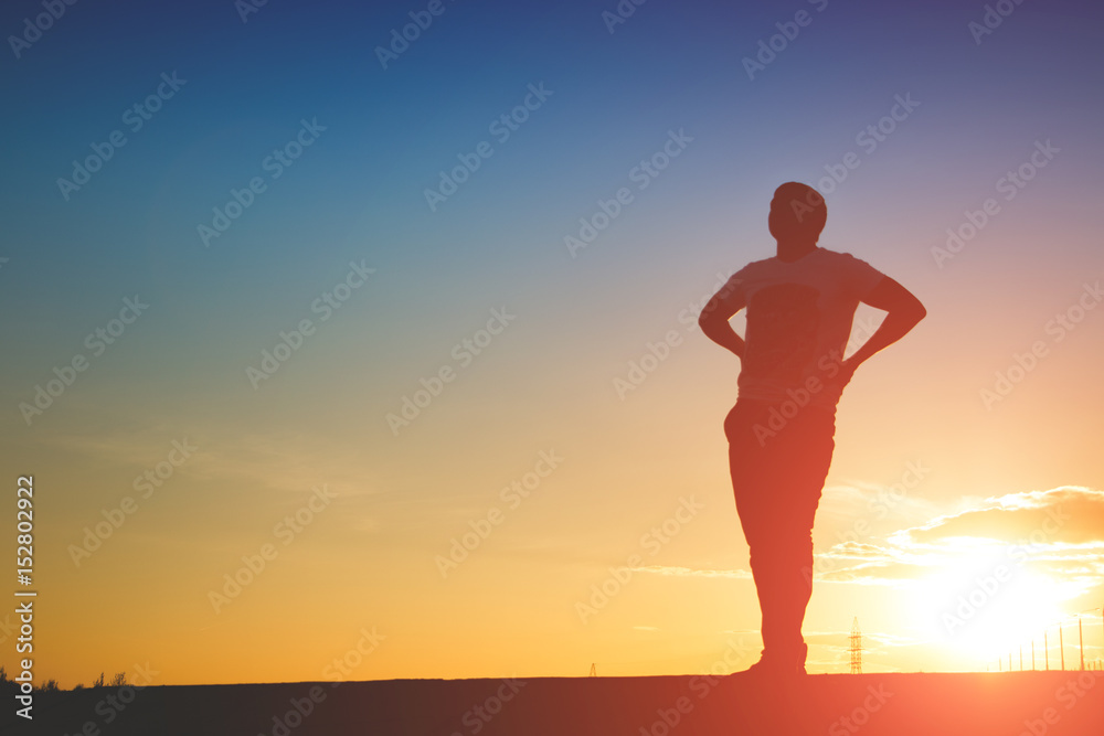 Man silhouette on sunset background