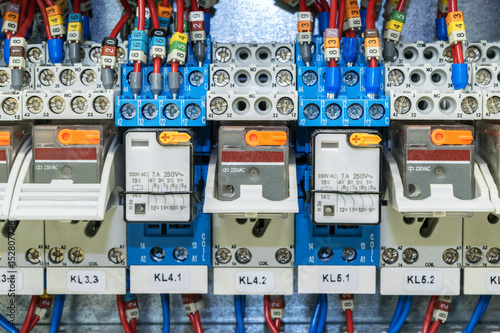 Some electrical relay is mounted on the mounting panel. Relays inserted in the base or socket. To the relay, wires connected with the terminals and marking.