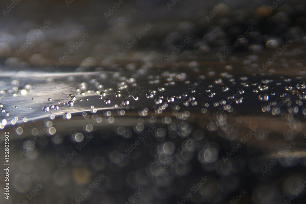 water drops on foil, black and brown background, focus, blurry