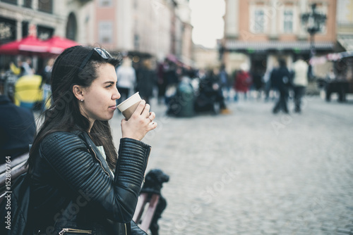woman drinks coffee outside