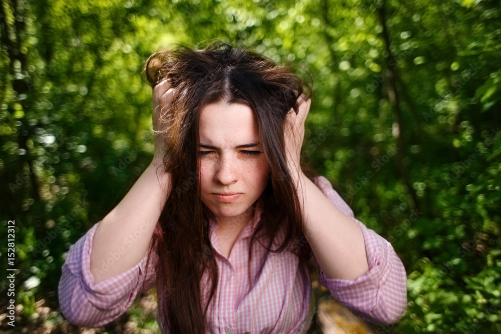 Portrait of extremely desperate, stressed woman with hands over head Portrait of extremely desperate, stressed woman with hands over head