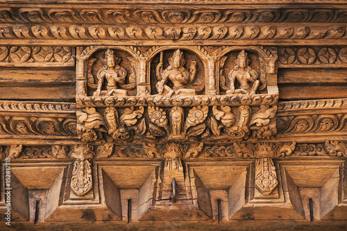 Hindu Temple wooden carved decor of an ancient building of 18 century on Durbar square, Kathmandu, Nepal, Asia. Architectural detail. Gods in Hinduism.